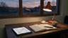 A quiet desk with a ledger, tablet, and invoice papers